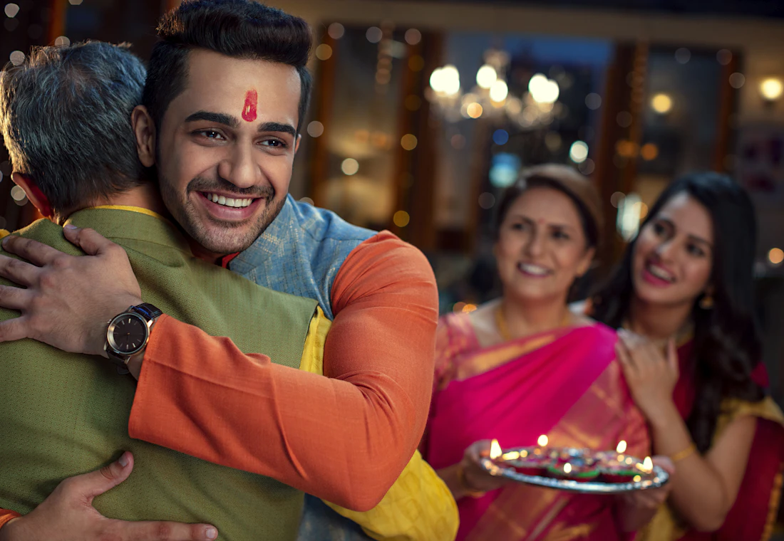 A family hugging at a festive gathering